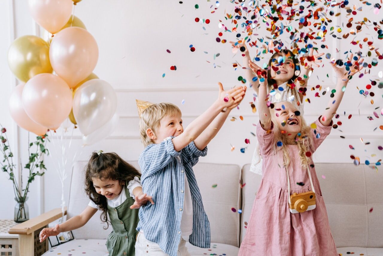 Children playing with glitter at their birthday party